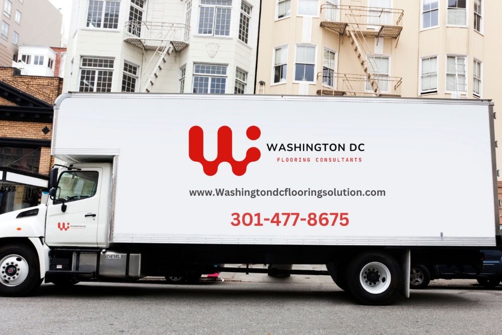 A moving truck is parked in front of a building that houses a flooring service in Washington, DC.