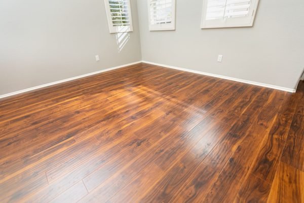 Elegant hardwood floor set against white walls, illustrating a laminate flooring service located in Washington, DC.
