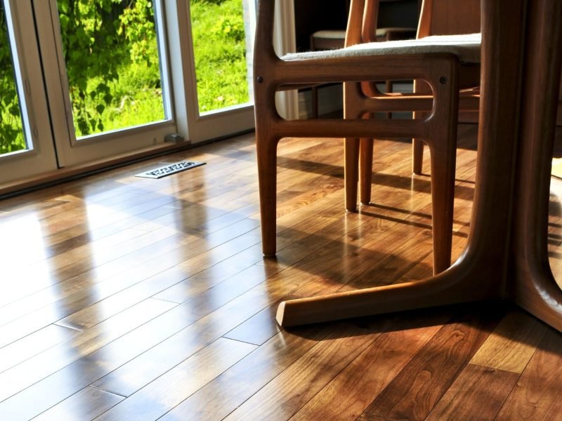 A dining room featuring a table and chairs, showcasing elegant flooring, highlighting a flooring service in Washington, DC.